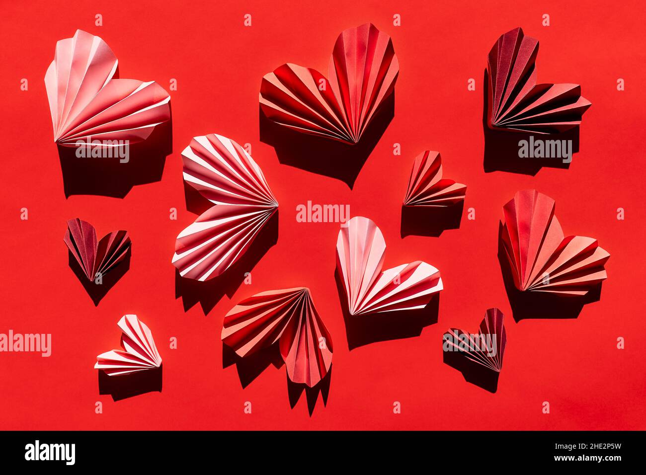 Paper hearts on red background. Symbol of love for valentines day ...