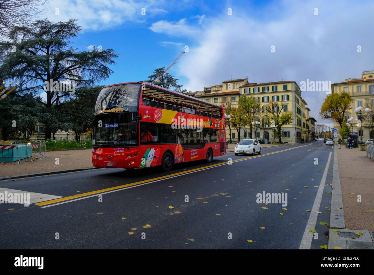 December 2021 Florence, Italy: Red sightseeing bus driving through the streets of the city Stock Photo