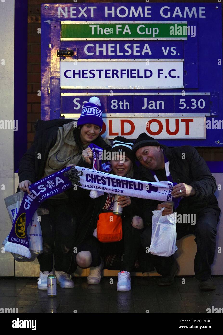 Chesterfield fans Laura Kennedy, Carla Millen and Brian Whitworth pose with a half-and-half-scarf before the Emirates FA Cup third round match at Stamford Bridge, London. Picture date: Saturday January 8, 2022. Stock Photo
