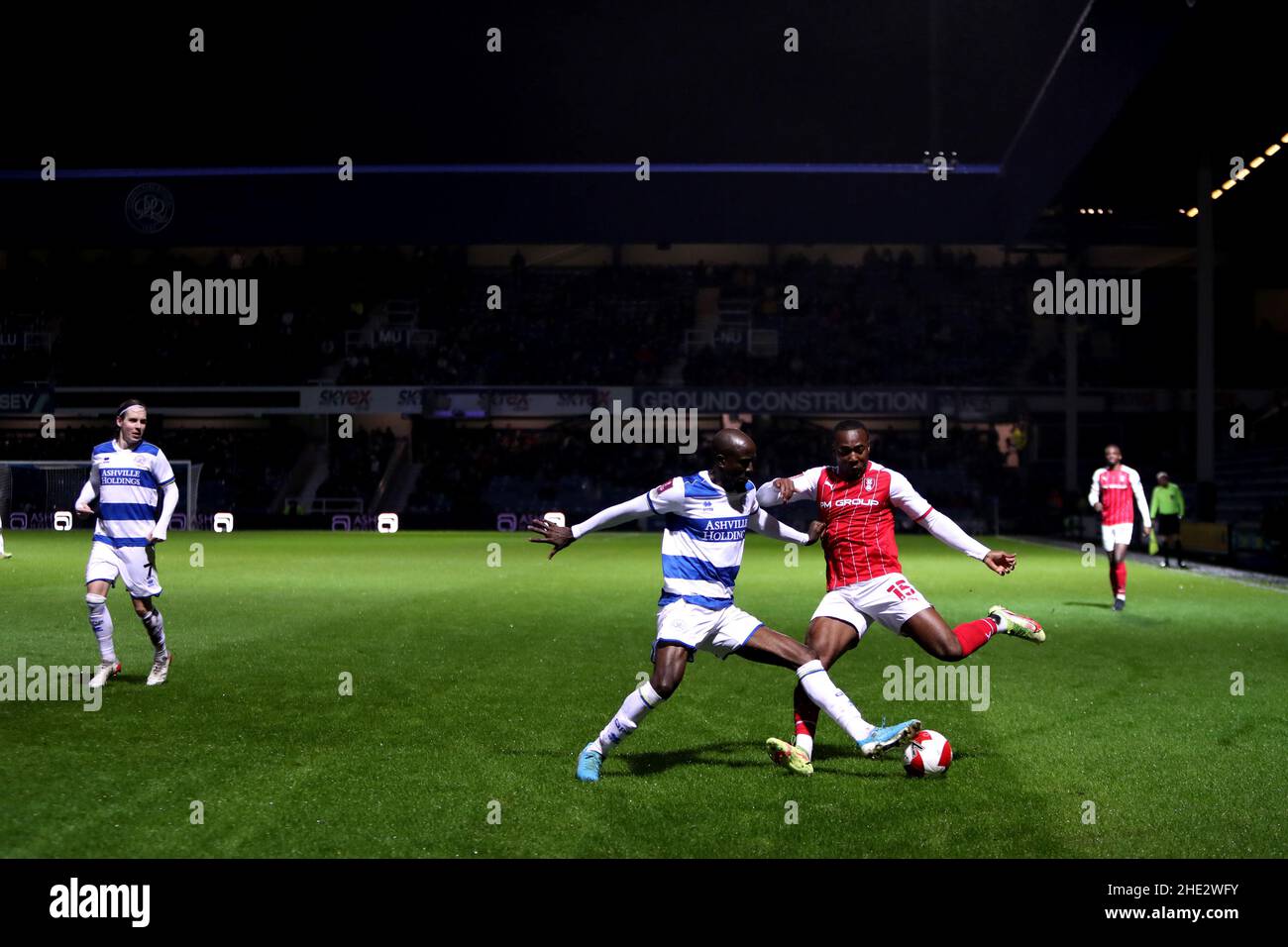 Queens Park Rangers' Albert Adomah (left) and Rotherham's Tolaji Bola battle for the ball during the Emirates FA Cup third round match at the Kiyan Prince Foundation Stadium, London. Picture date: Saturday January 8, 2022. Stock Photo