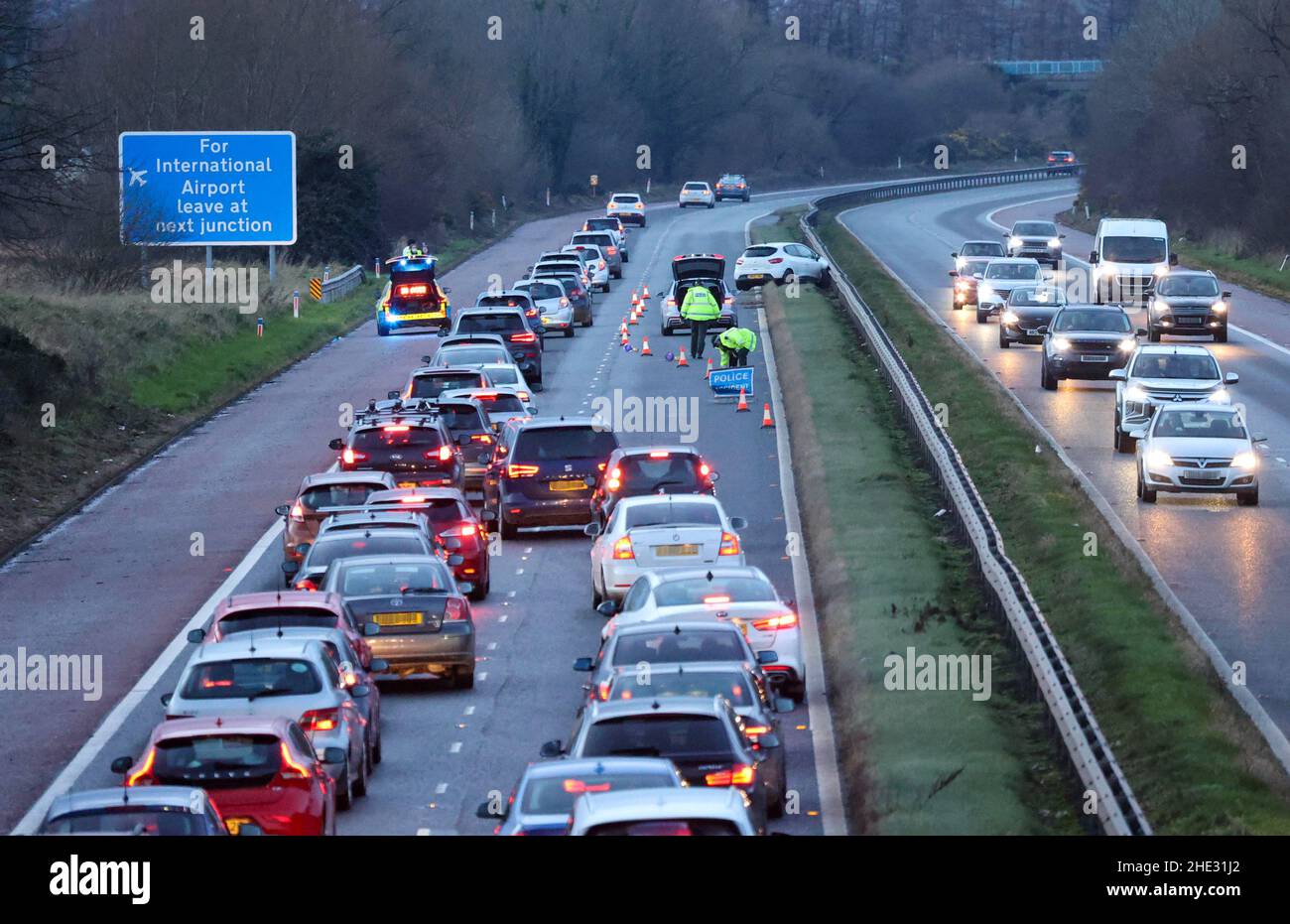 M1 Motorway near Moira, County Down, Northern Ireland. 08 Jan 2022. 16.22 GMT, a late afternoon motorway accident when a white car collided with the central reservation barrier has caused tailbacks on the motorway with traffic being funnelled into one lane. Credit: CAZIMB/Alamy Live News. Stock Photo