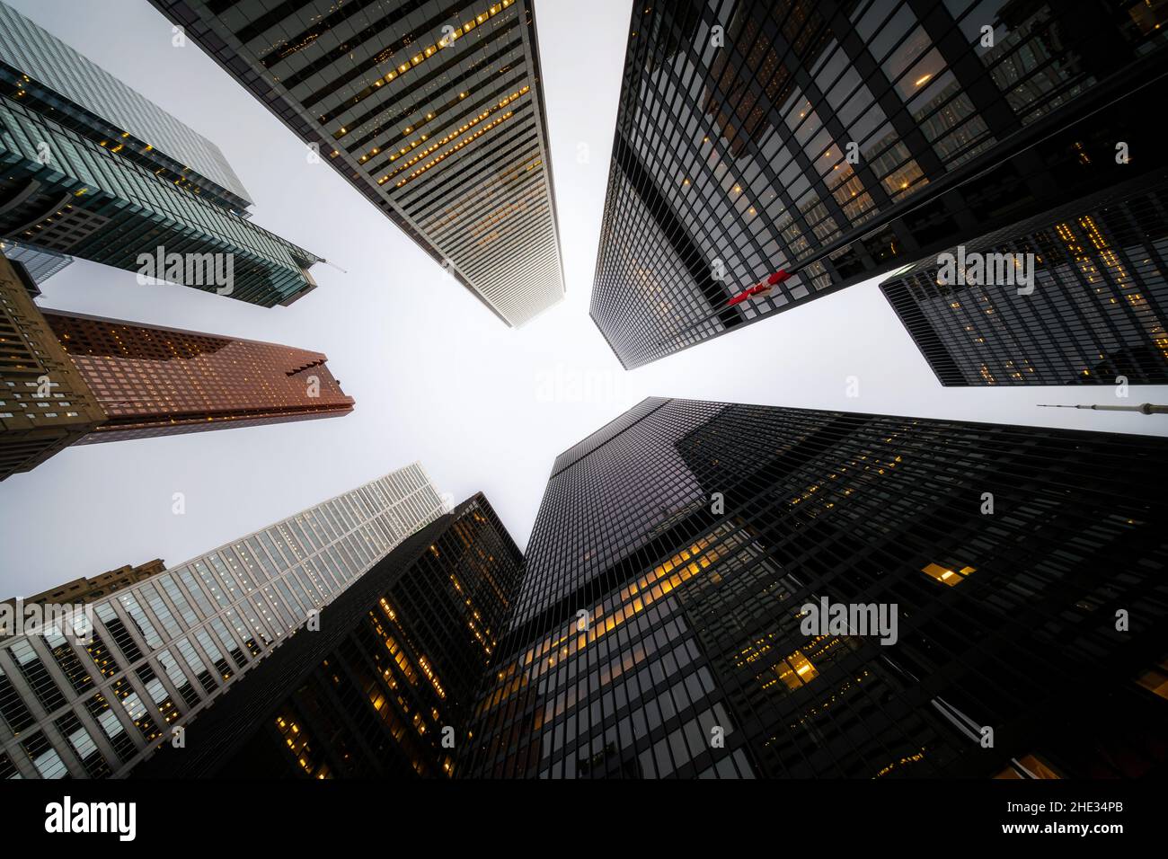 Business and finance concept, looking up at high rise office building architecture at dusk in the financial district of a modern metropolis. Stock Photo