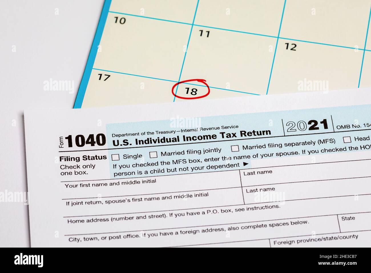 Income tax return form and calendar with filing deadline date. April 18 tax due date, financial information Stock Photo