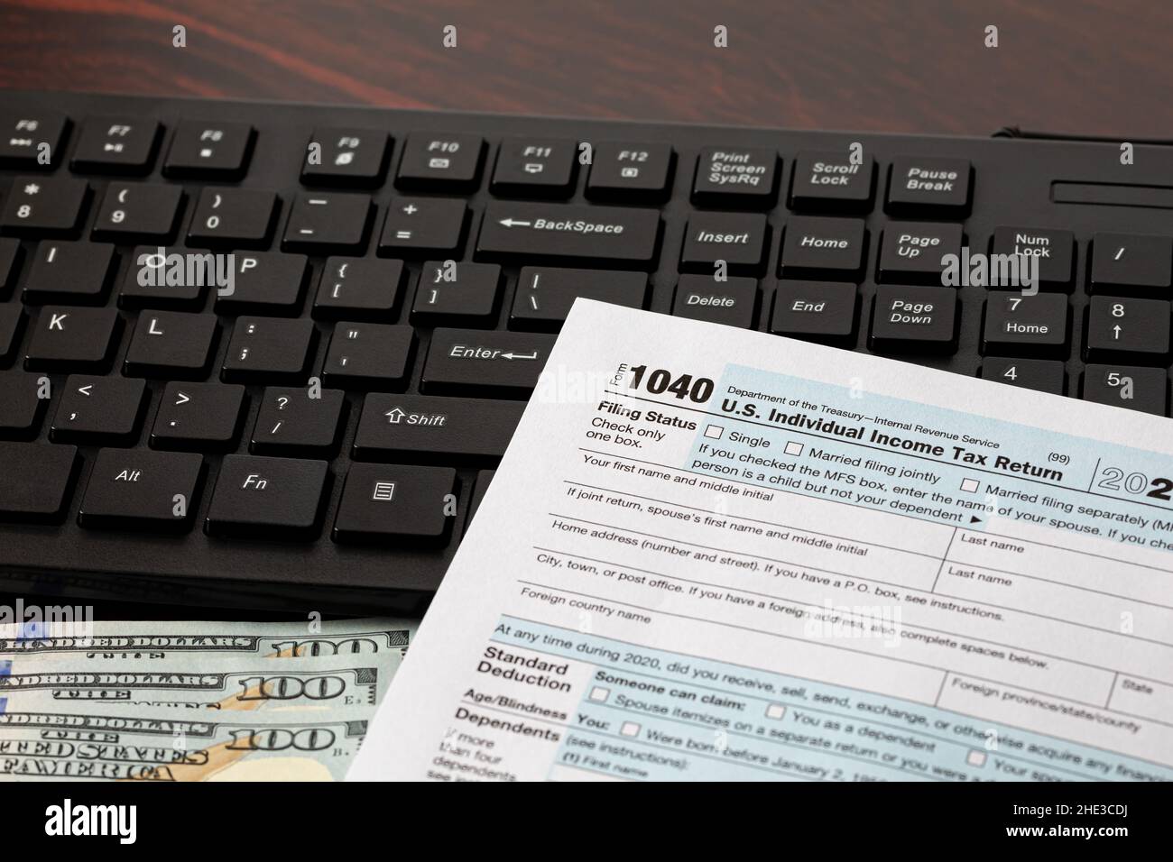 Income tax return and computer keyboard. Online filing, tax software and e-file concept. Stock Photo