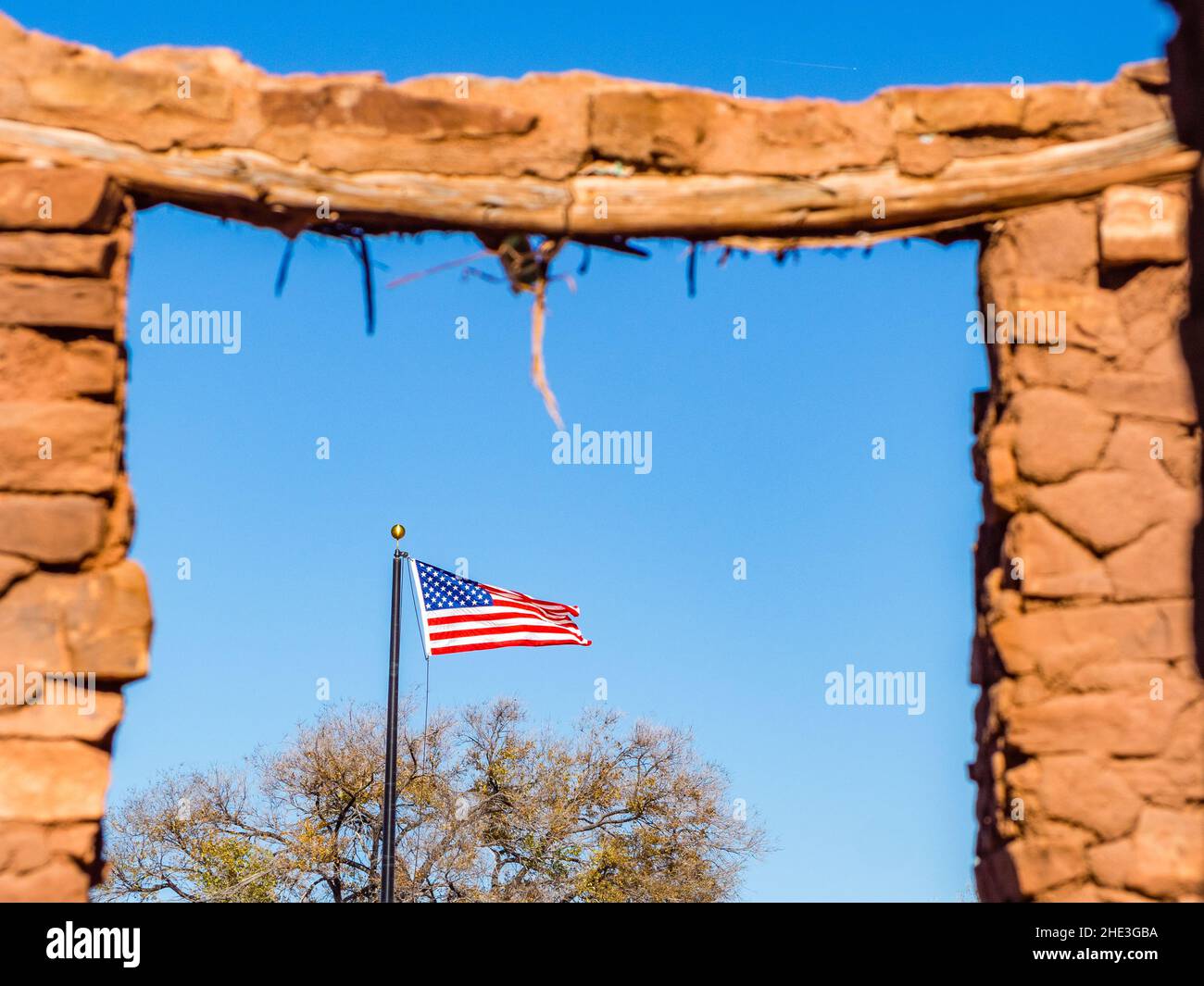 American flag framed by door in ruins of old adobe building at Abo site in the Salinas Pueblo Missions National Monument near Mountainair, NM. Stock Photo