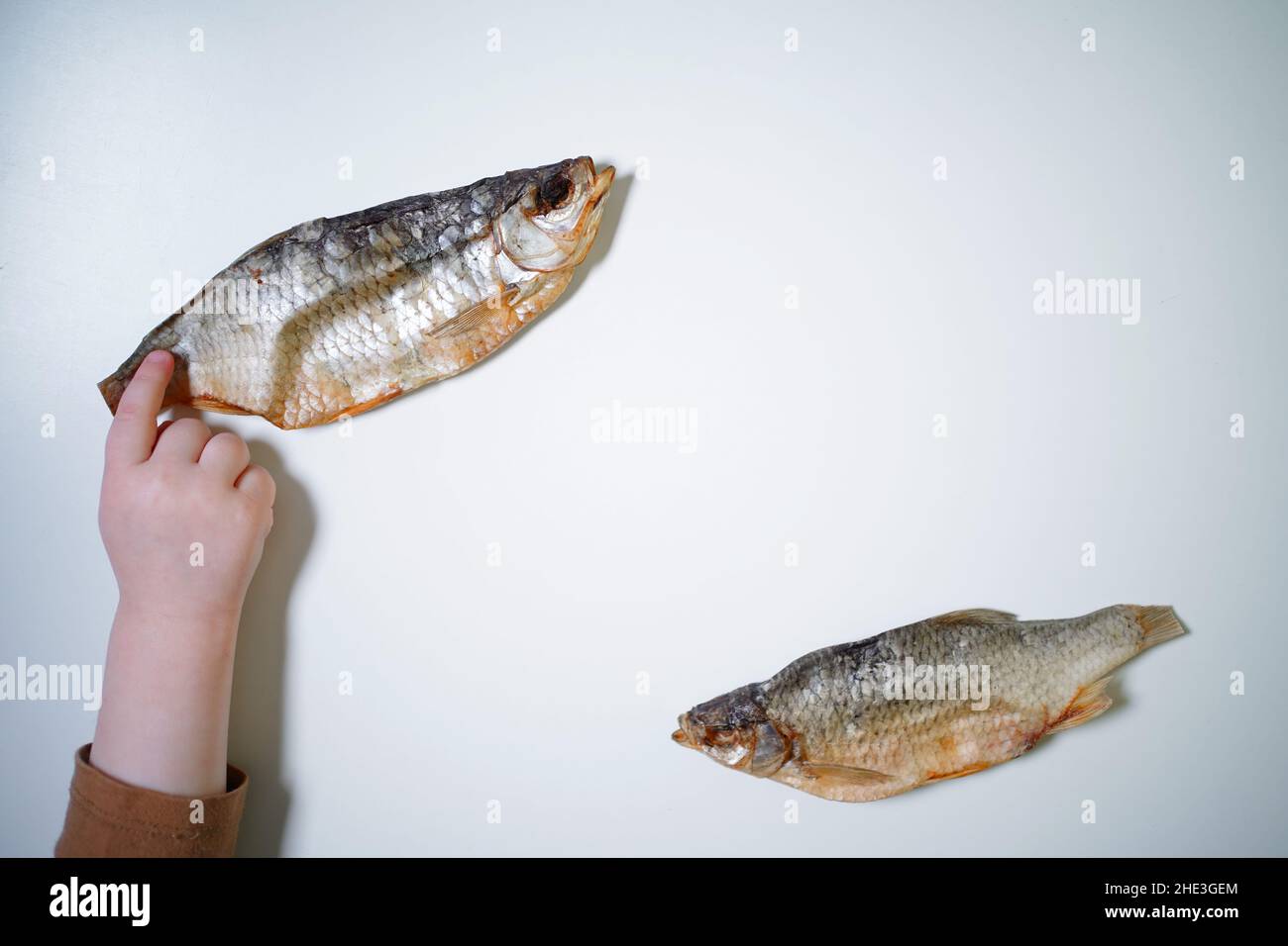Dried fish on a white background, top view, copy space. Stock Photo