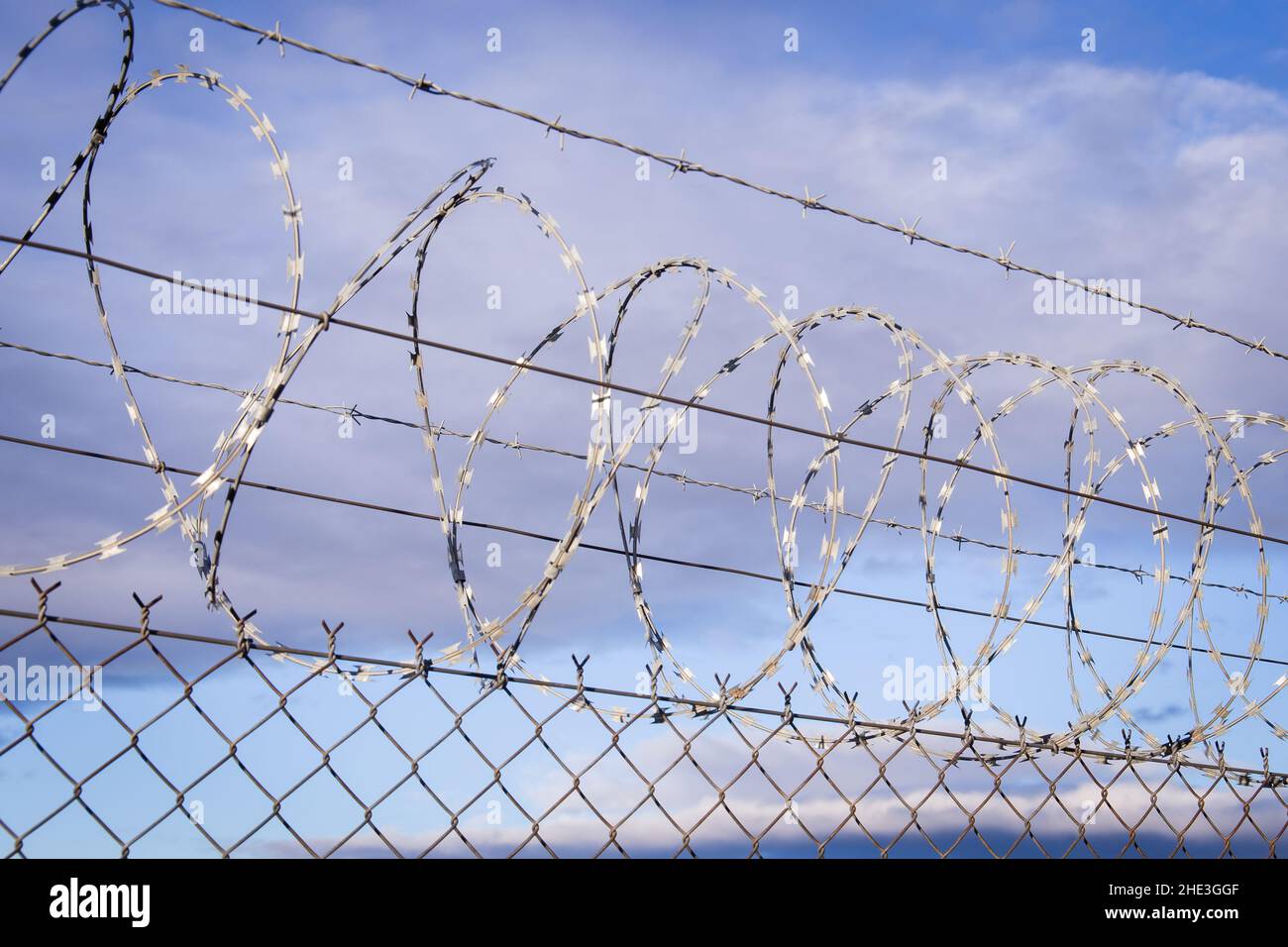 NATO barb wire with sharp and dangerous razor blades mounted on a