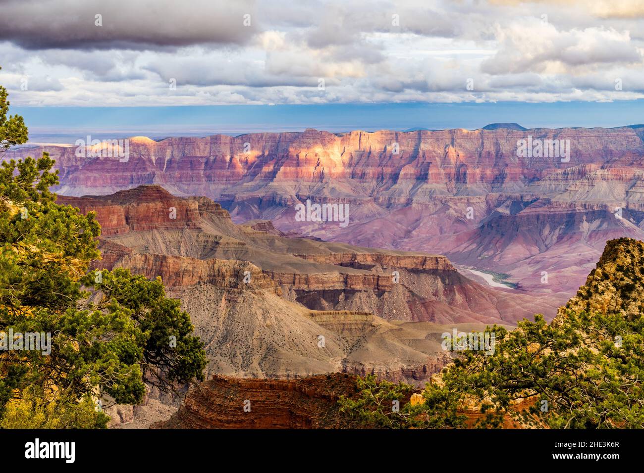 Grand Canyon with Colorado River in distance white clouds overhead and ...