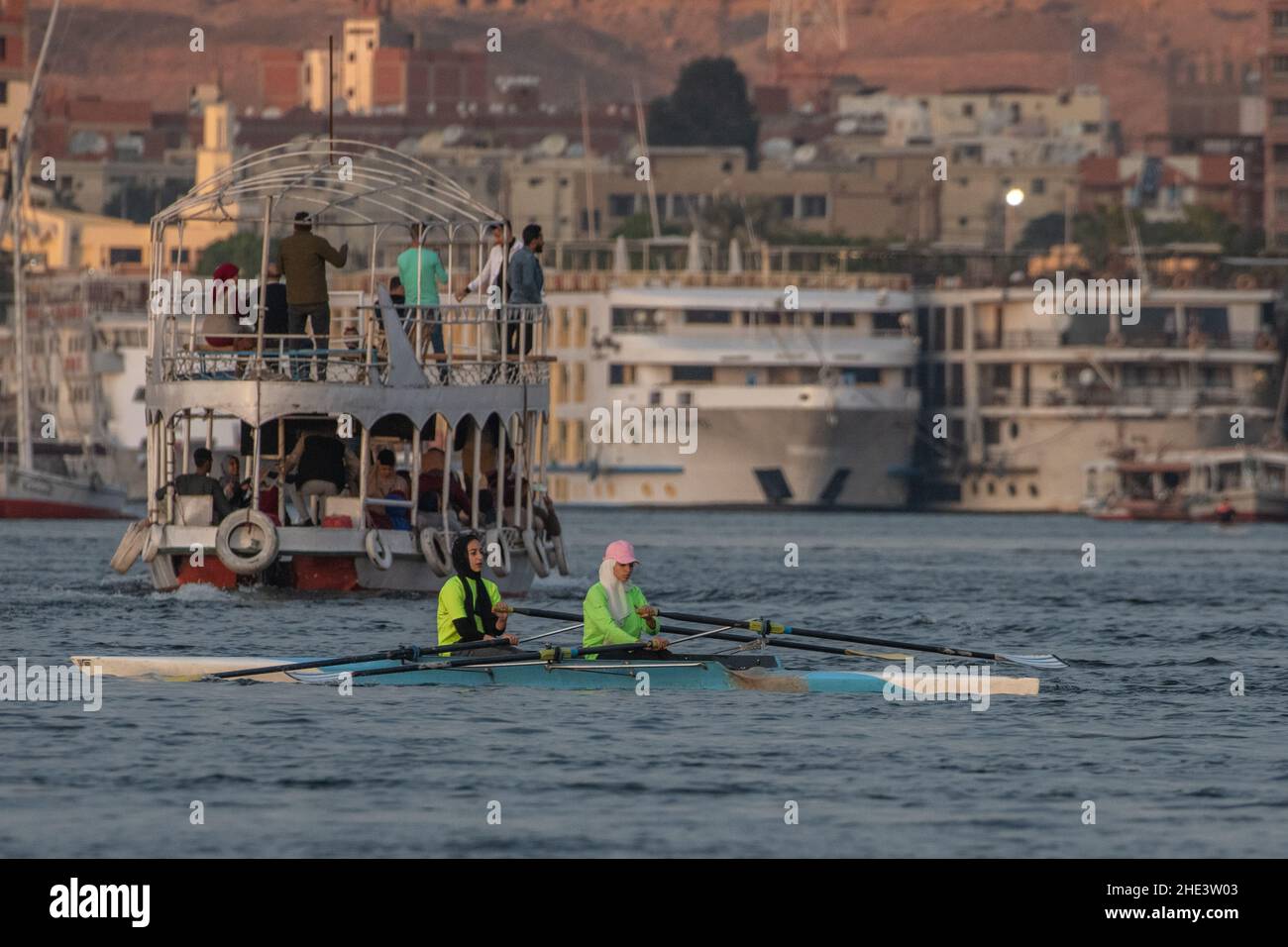 Female rowers training in a double scull on the Nile river in Aswan, Egypt. Stock Photo