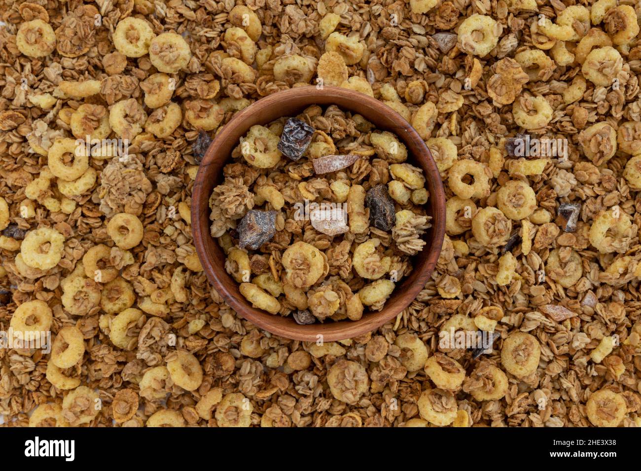 crunchy granola with nuts and fruits in wooden bowl on muesli