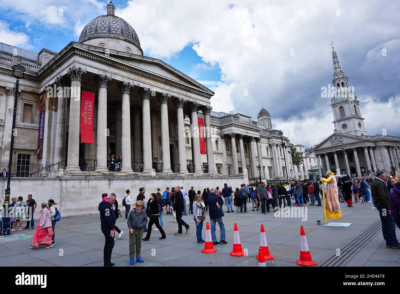 Tourists walking in front of the National Gallery, art museum in Trafalgar Square, Westminster Stock Photo