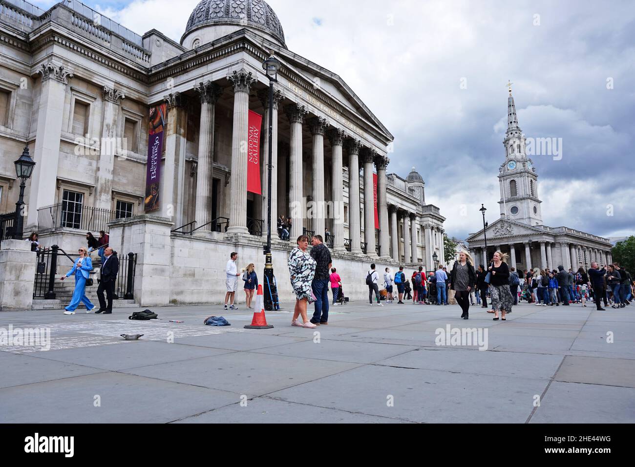 Tourists walking in front of the National Gallery, art museum in Trafalgar Square, Westminster Stock Photo
