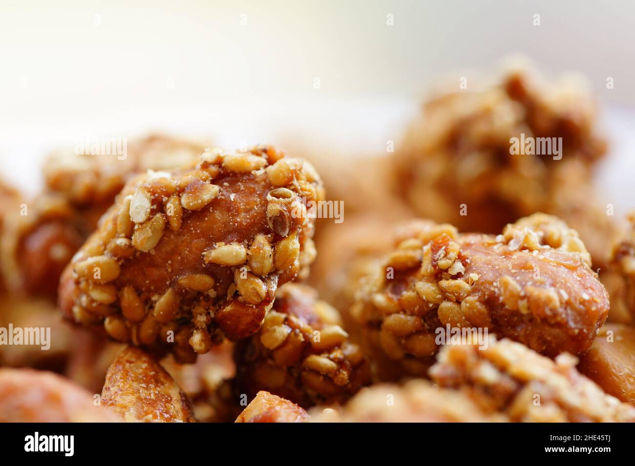 Peanuts covered with honey and sesame seeds Stock Photo Alamy