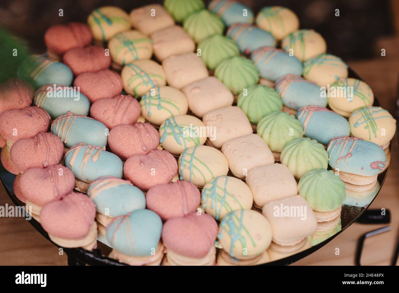 Close-up shot of fresh small colorful cakes on a table Stock Photo