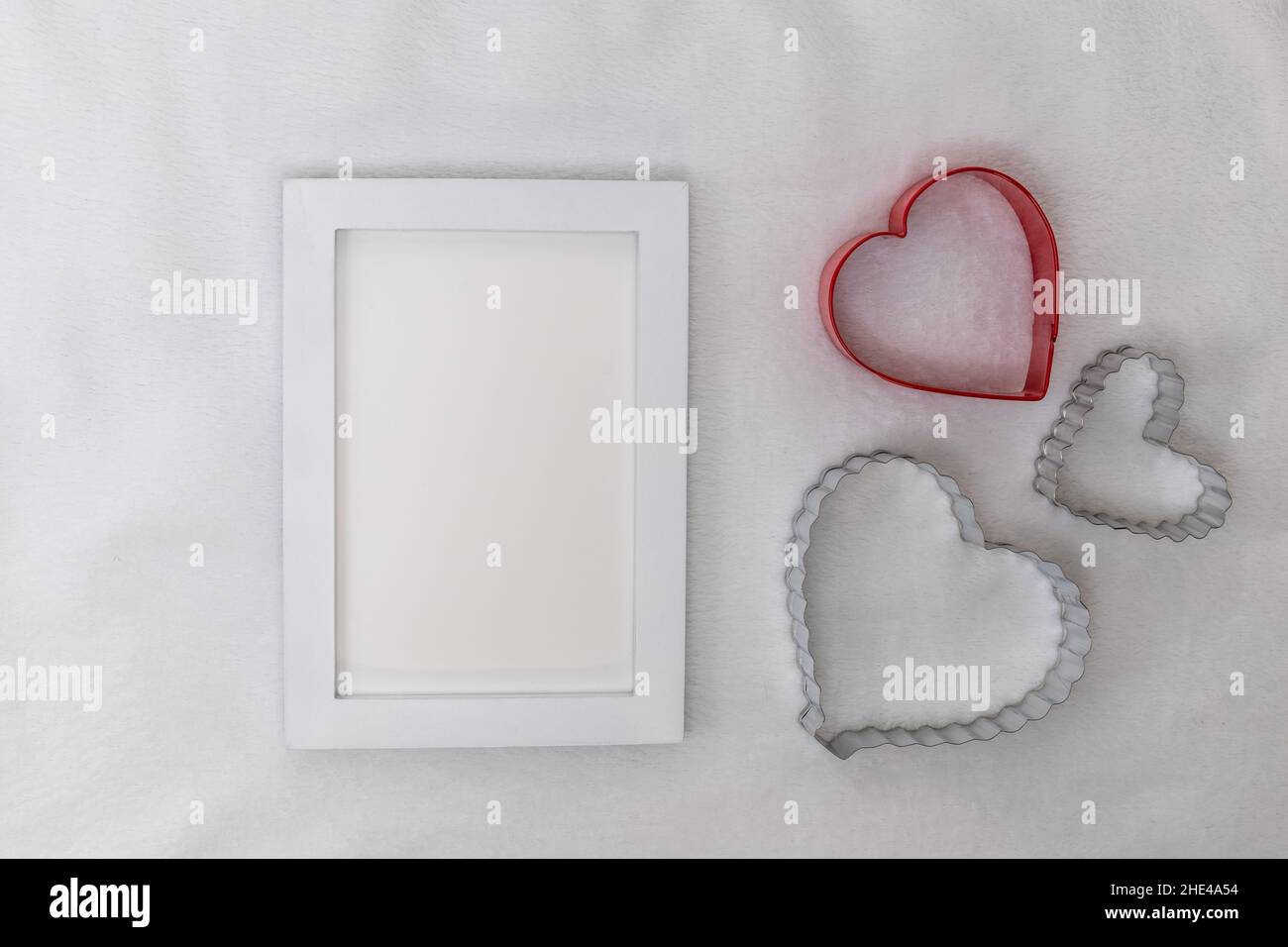 White frame mockup on white plush background with heart shapes flat lay for Valentine's Day, Mother's Day, Anniversary, add your text, logo, artwork Stock Photo