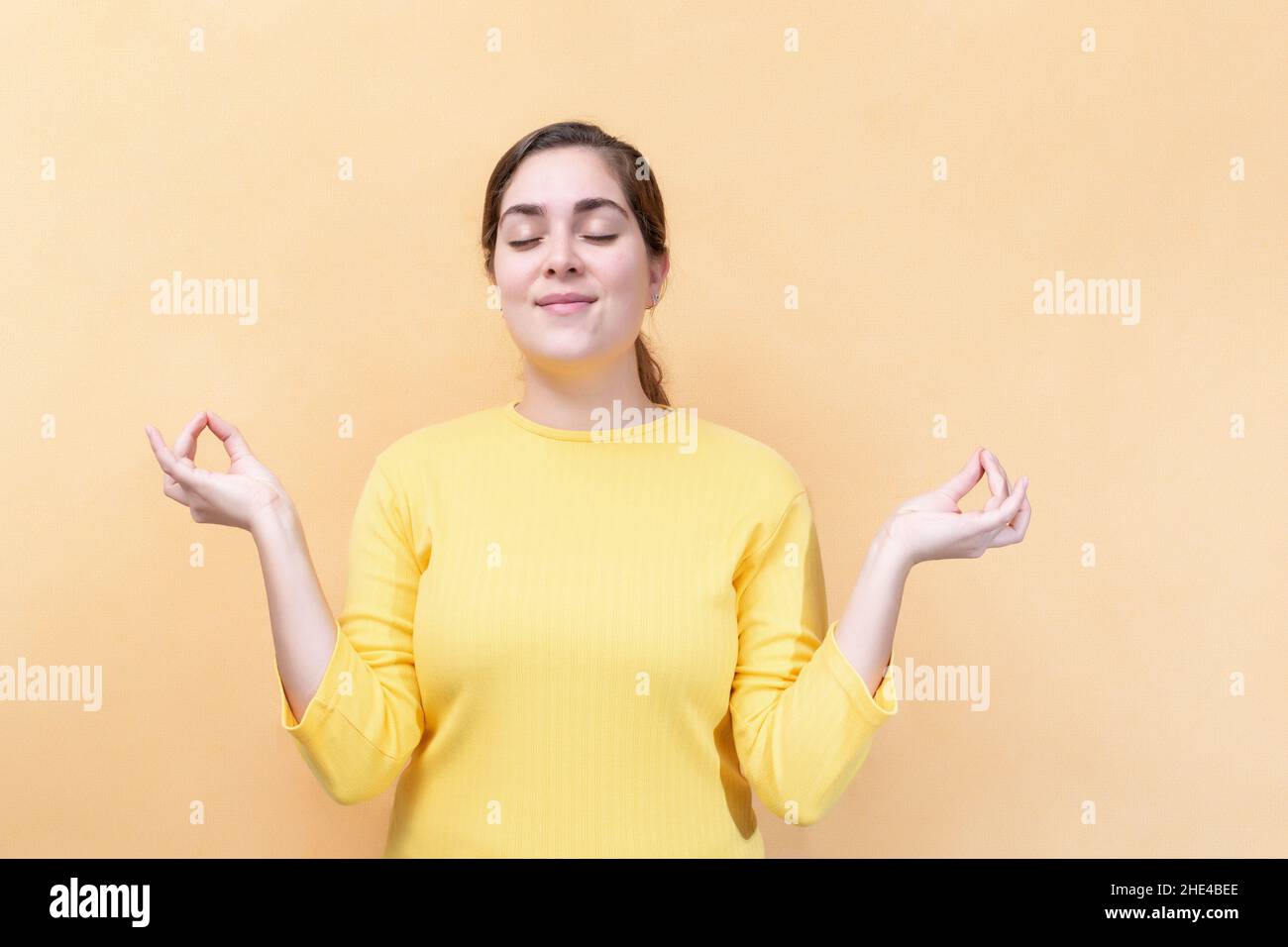 Hold hands in yoga gesture relaxing meditating keeping eyes closed