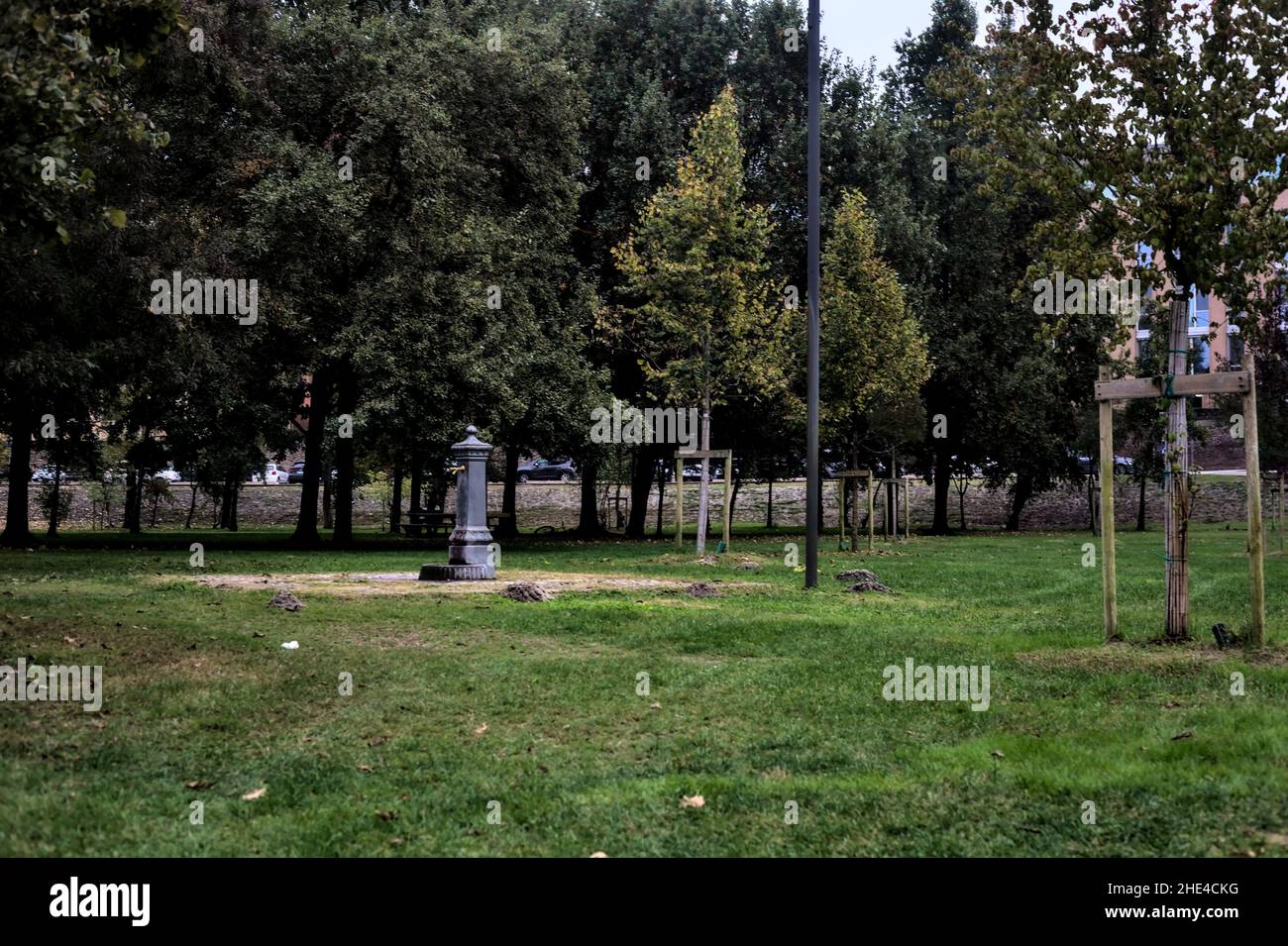 Public fountain in a park with trees in the background Stock Photo - Alamy