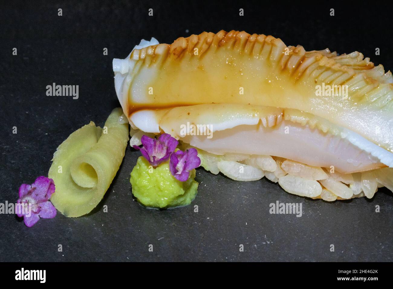 Closeup of a well prepared seashell that looks delicious with its sauce Stock Photo