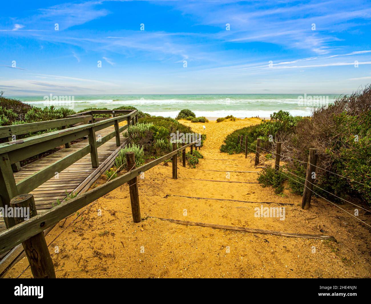 View of a clean and quiet beach with clear sky, no people. Entrance to the Ninety Mile Beach in Victoria, Australia. Stock Photo