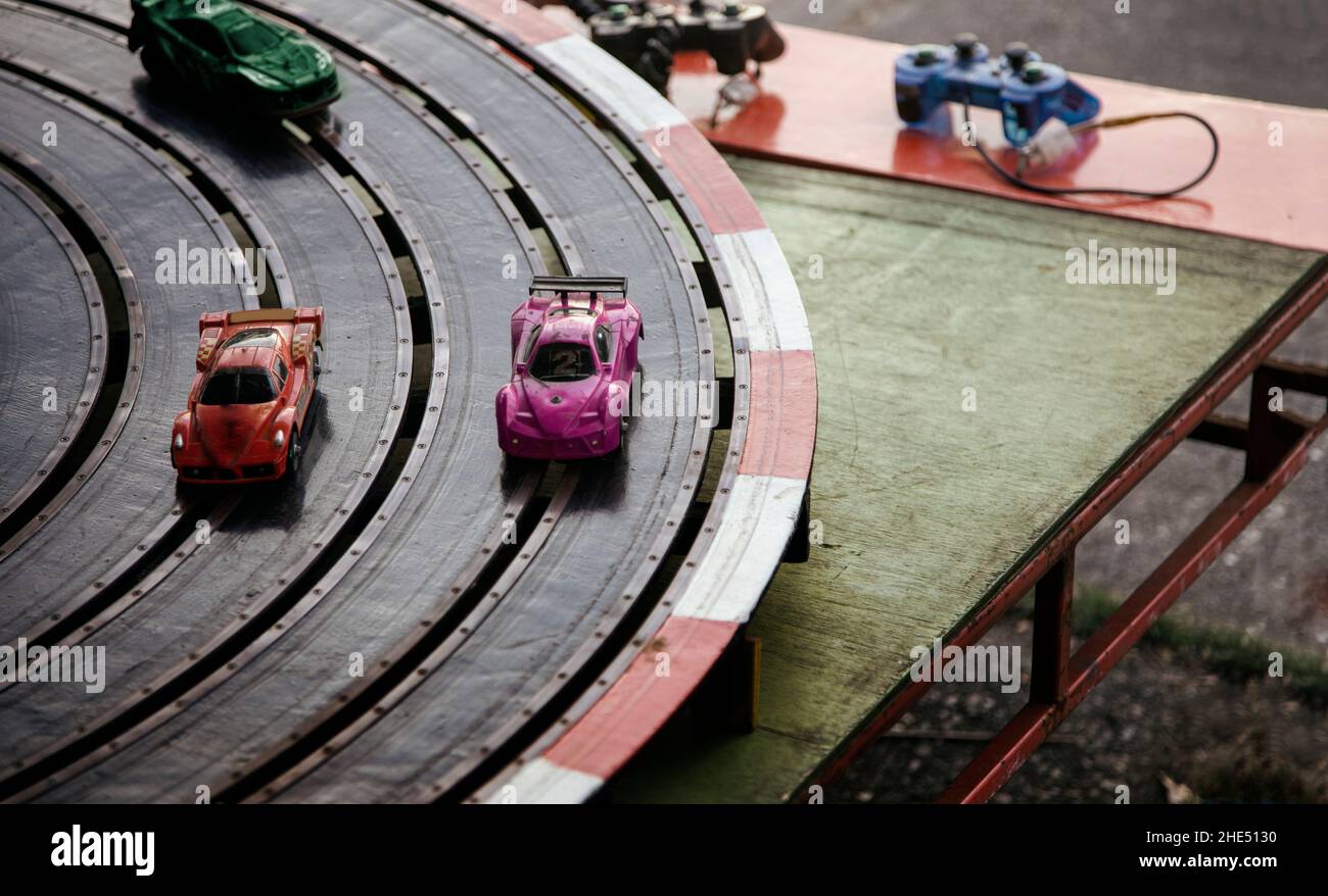 vintage racing game with electric control on track road with color cars