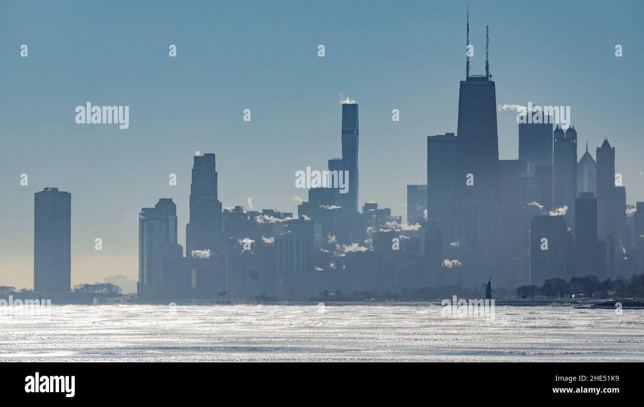 Silhouette of the Chicago skyline on a winter morning with ice forming ...