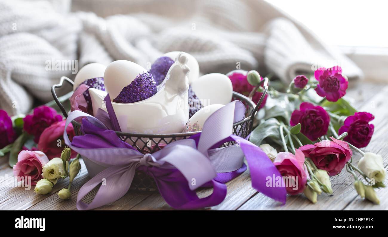 Easter composition with eggs, decorated with purple sparkles. Stock Photo