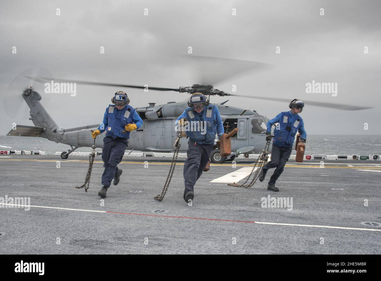 Sailors conduct a chock and chain evolution with an SH-60 Sea Hawk aboard USS Wasp. (21856860402). Stock Photo