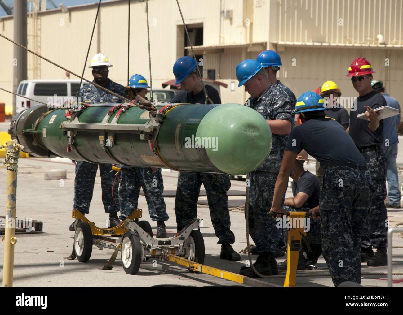 Sailors lower a torpedo to the pier. (8200233030 Stock Photo - Alamy