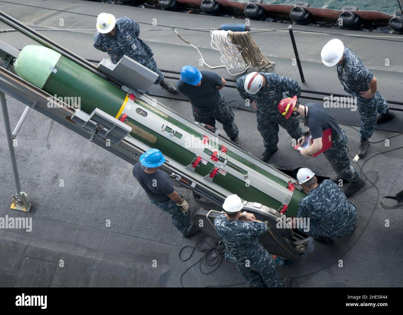 Sailors remove a torpedo from USS Oklahoma City. (8199141205 Stock ...