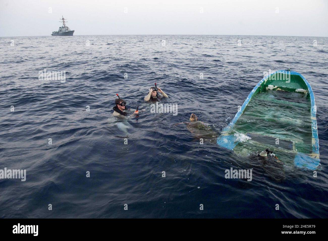 Sailors rescue a loggerhead sea turtle entangled on a semi-sunken fishing vessel. (37534831270). Stock Photo