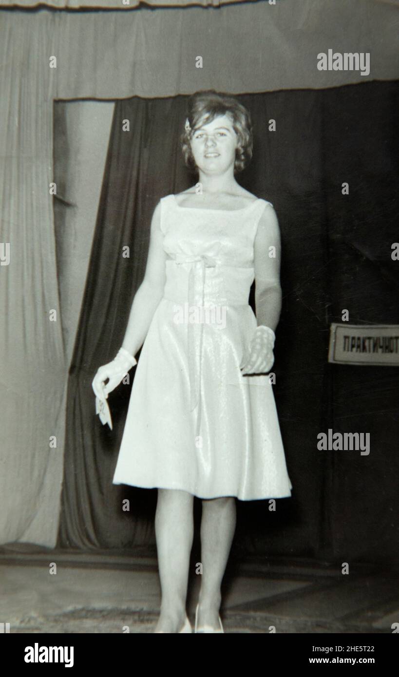 Female model catwalking on platform ramp demonstrating clothing at an indoor fashion show in the 1960s, Bulgaria, Eastern Europe Stock Photo