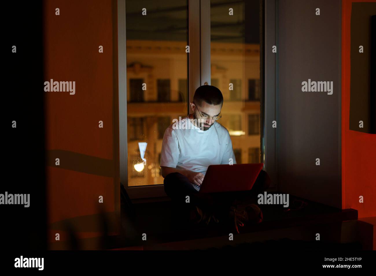 Workaholic specialist work overtime. Programmer on remote outsource occupation. Nighttime lifestyle Stock Photo