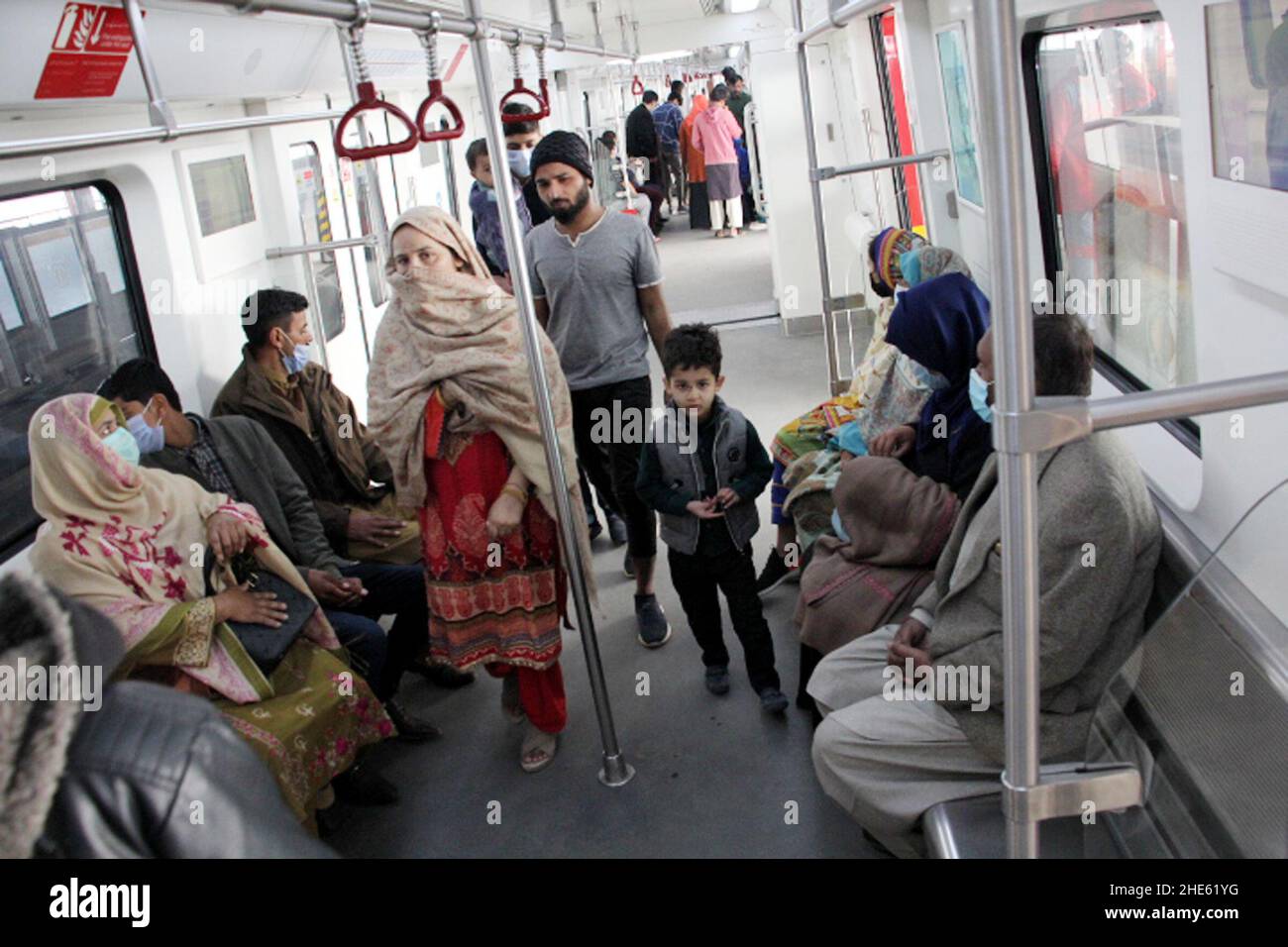 Lahore, Pakistan. 29th Dec, 2021. People take the Orange Line metro train in Lahore, Pakistan, Dec. 29, 2021. Officially open to traffic on Oct. 25, 2020, the eco-friendly Orange Line metro train is an early project under the China-Pakistan Economic Corridor (CPEC), a flagship project of the China-proposed Belt and Road Initiative. TO GO WITH 'Feature: Lahore Orange Line, epitome of China-Pakistan friendship' Credit: Jamil Ahmed/Xinhua/Alamy Live News Stock Photo