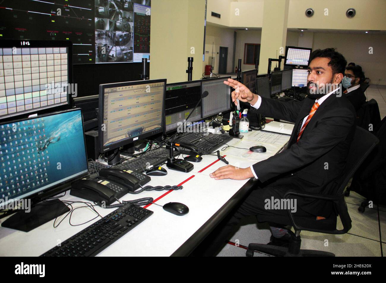 Lahore, Pakistan. 29th Dec, 2021. Mohammad Nauman works at the control room of the terminal station of the Orange Line in Lahore, Pakistan, Dec. 29, 2021. Officially open to traffic on Oct. 25, 2020, the eco-friendly Orange Line metro train is an early project under the China-Pakistan Economic Corridor (CPEC), a flagship project of the China-proposed Belt and Road Initiative. TO GO WITH 'Feature: Lahore Orange Line, epitome of China-Pakistan friendship' Credit: Jamil Ahmed/Xinhua/Alamy Live News Stock Photo