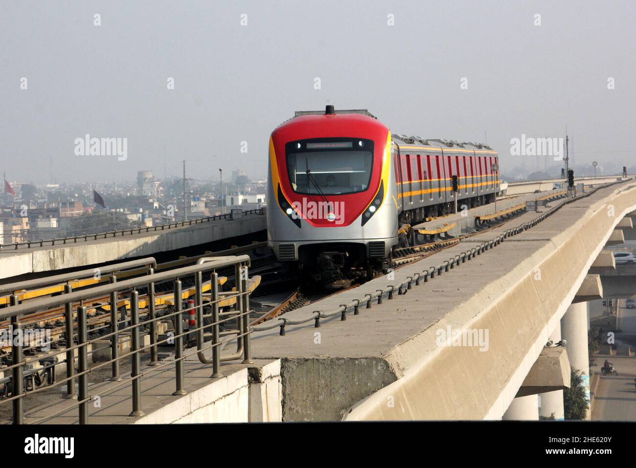 Lahore, Pakistan. 29th Dec, 2021. An Orange Line metro train pulls into the terminal station in Lahore, Pakistan, Dec. 29, 2021. Officially open to traffic on Oct. 25, 2020, the eco-friendly Orange Line metro train is an early project under the China-Pakistan Economic Corridor (CPEC), a flagship project of the China-proposed Belt and Road Initiative. TO GO WITH 'Feature: Lahore Orange Line, epitome of China-Pakistan friendship' Credit: Jamil Ahmed/Xinhua/Alamy Live News Stock Photo
