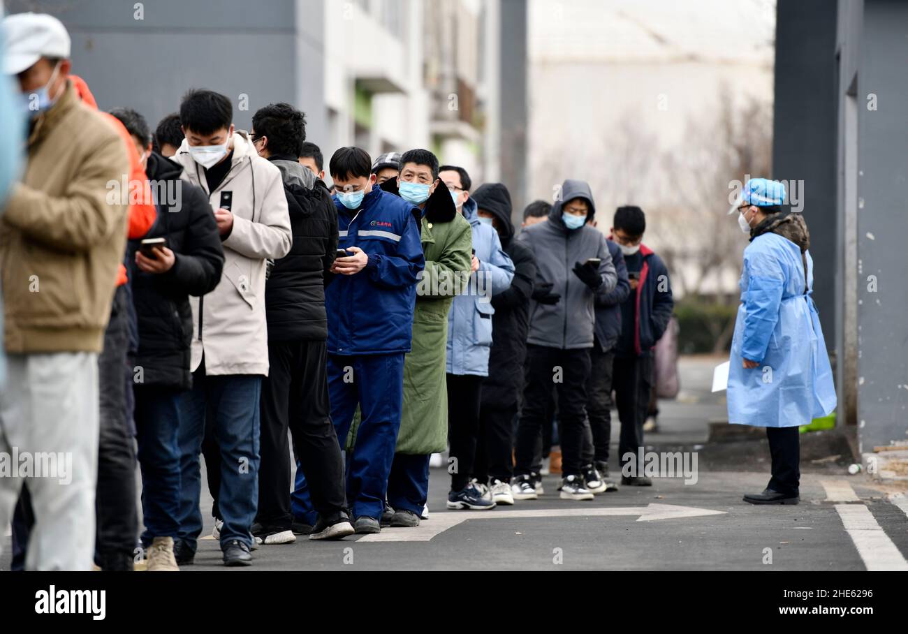 Tianjin, China. 09th Jan, 2022. Citizens line up for nucleic acid test at a testing site in Binhai New Area in north China's Tianjin, Jan. 9, 2022. North China's Tianjin, a municipality that neighbors Beijing, has decided to start a citywide nucleic acid testing after 20 people tested positive for COVID-19, authorities said Sunday. The infections were reported from 6 p.m. Friday to 9 p.m. Saturday in Jinnan District, and the gene sequencing found the first two locally transmitted confirmed cases were infected with the VOC/Omicron variant, according to the municipal headquarters Credit: Xinhua/ Stock Photo