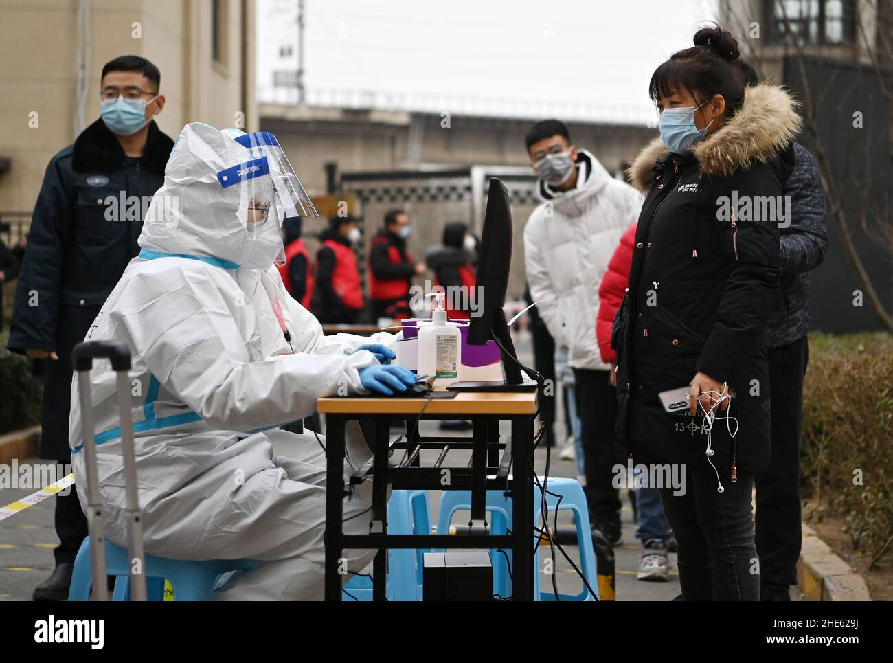 Tianjin, China. 09th Jan, 2022. Citizens line up for registration before nucleic acid test at a testing site of a residential area in Xiqing District in north China's Tianjin, Jan. 9, 2022. North China's Tianjin, a municipality that neighbors Beijing, has decided to start a citywide nucleic acid testing after 20 people tested positive for COVID-19, authorities said Sunday. The infections were reported from 6 p.m. Friday to 9 p.m. Saturday in Jinnan District, and the gene sequencing found the first two locally transmitted confirmed cases were infected with the VOC/Omicron varian Credit: Xinhua/ Stock Photo