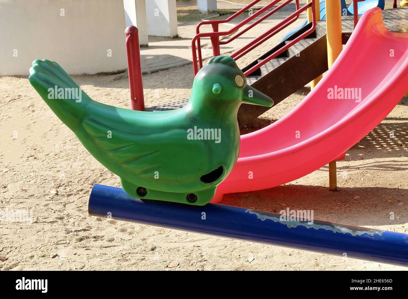 Children Playground, Plastic Bird Seesaw, Teeter Totter or Teeterboard in Outdoor Park. Stock Photo