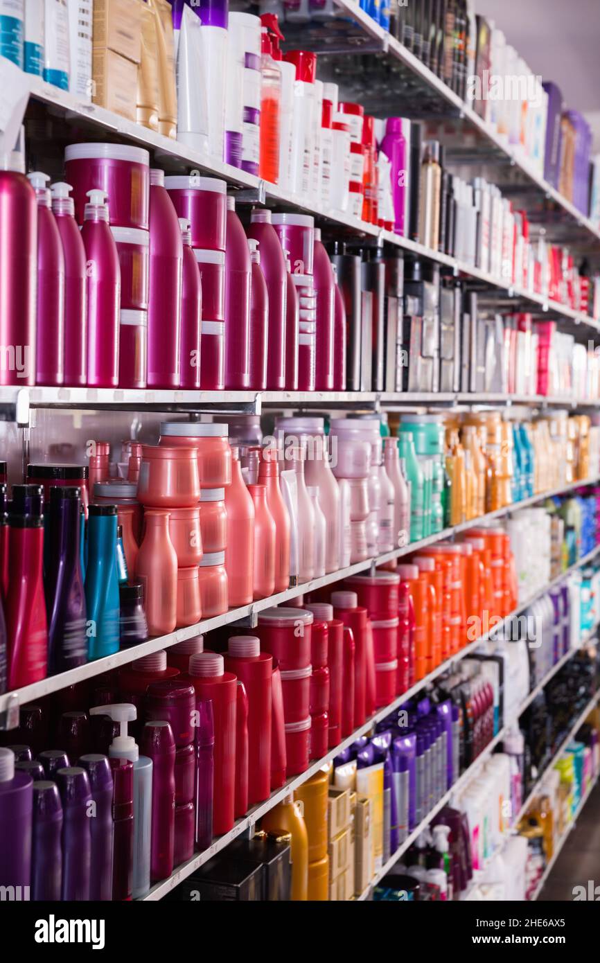 Image of shelves with conditioners and mousses for hair in the store. Stock Photo