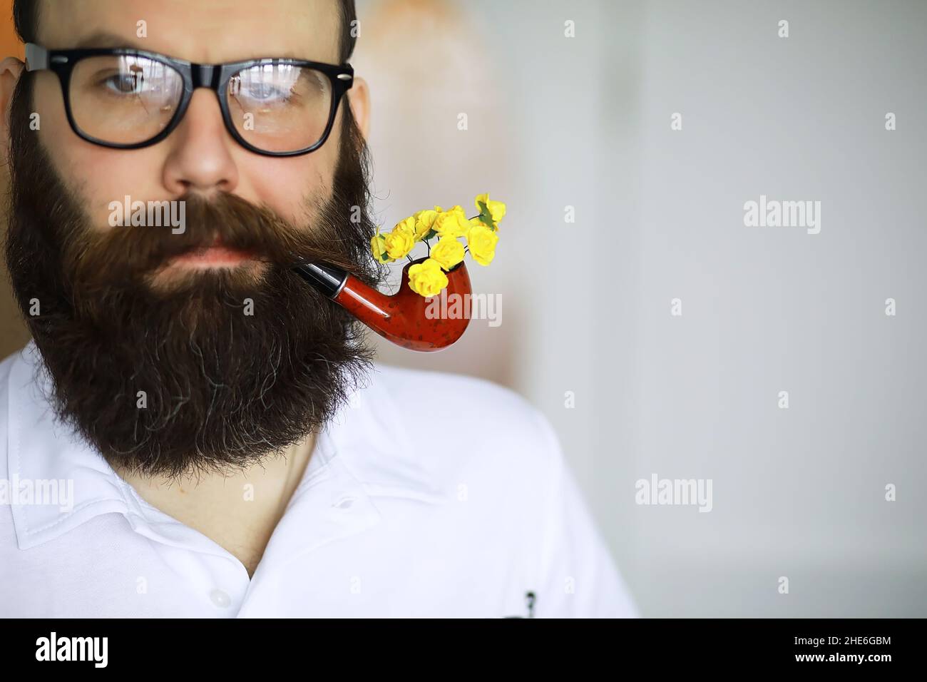 Handsome man or lumberjack, bearded hipster, beard and mustache in shirt  with smoking pipe Stock Photo - Alamy