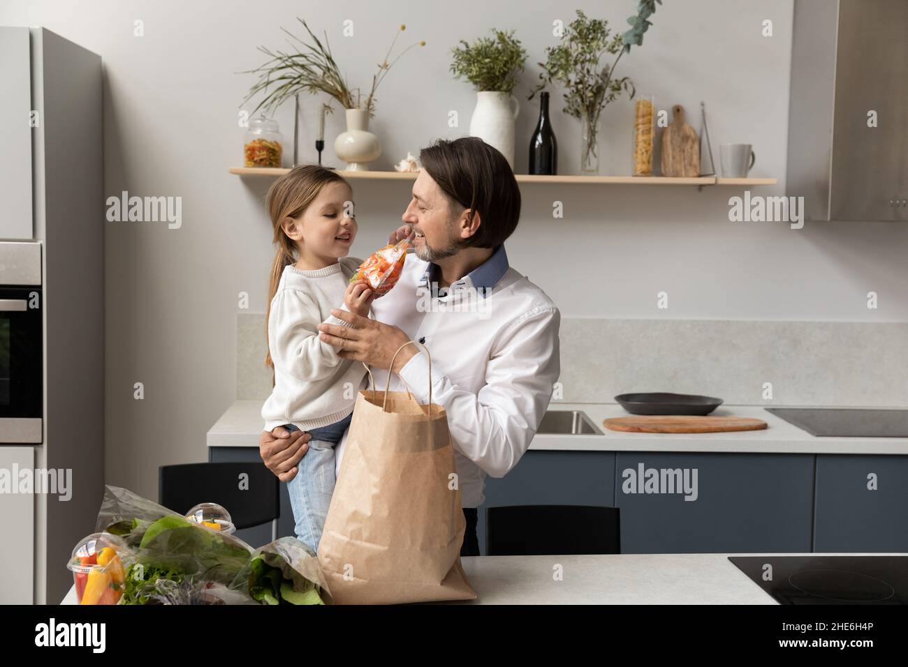 Happy dad holding adorable little daughter child in arms Stock Photo