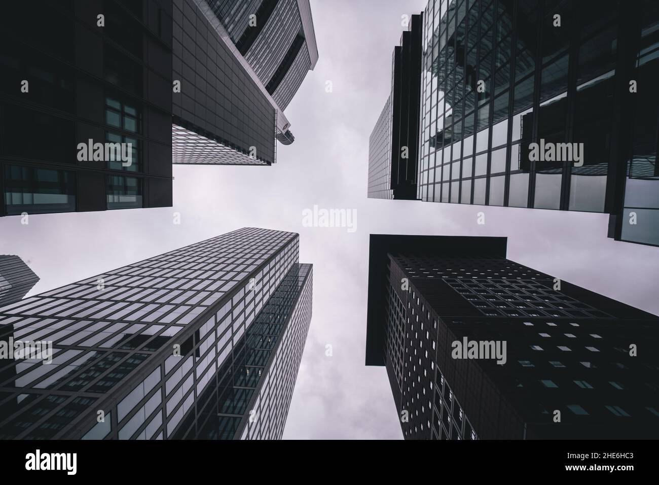 Low angle shot of skyscrapers under the cloudy sky Stock Photo - Alamy