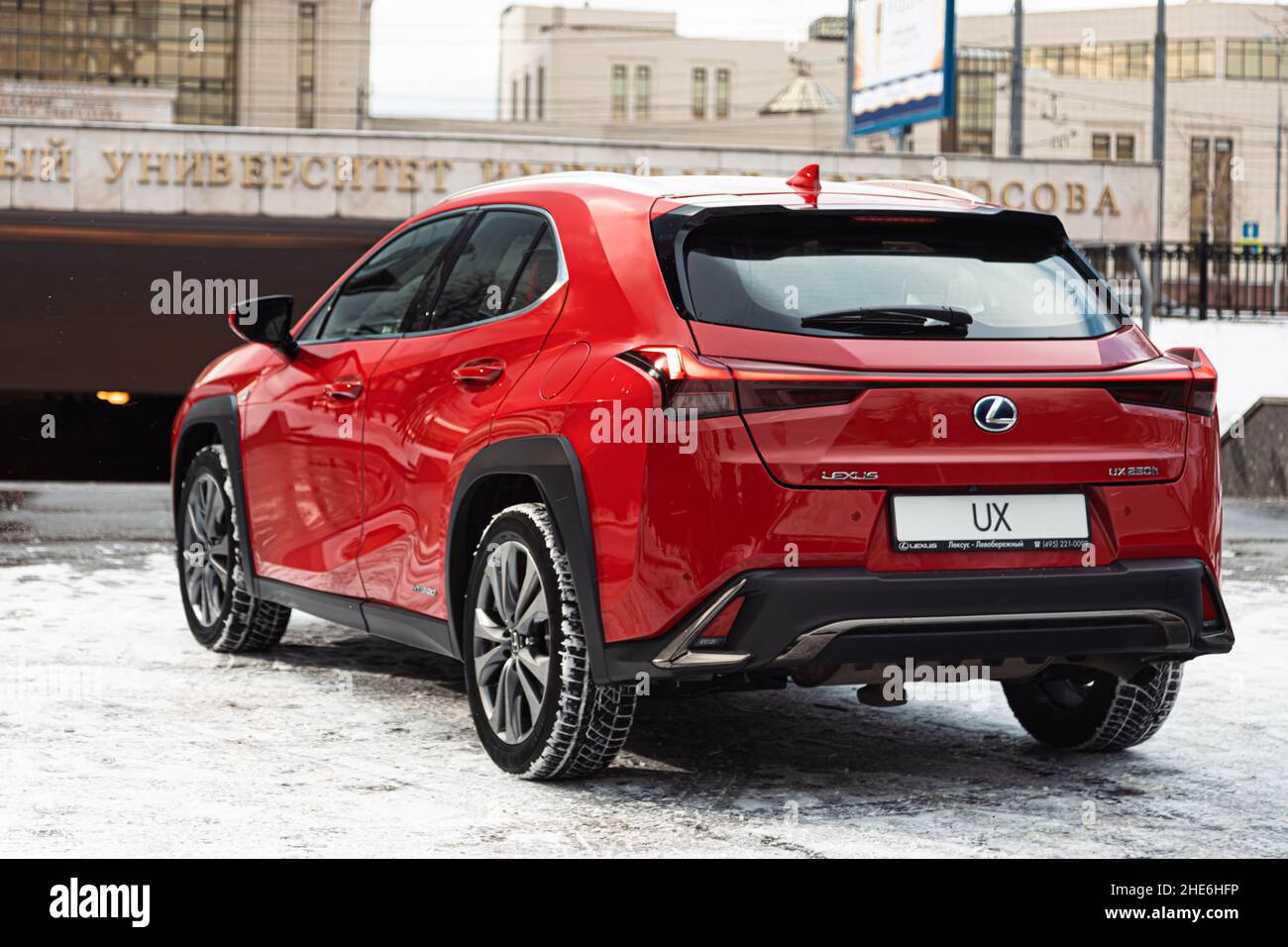 Russia, Moscow - February 05, 2020: Red premium crossover hatchback Lexus UX on the city streets. Hybrid car in winter Stock Photo