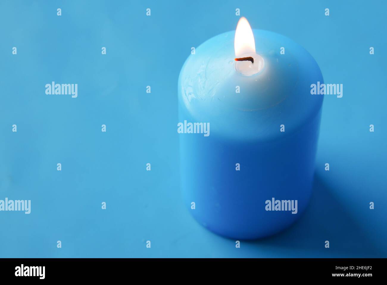 blue color candles slowly burning down Stock Photo Alamy