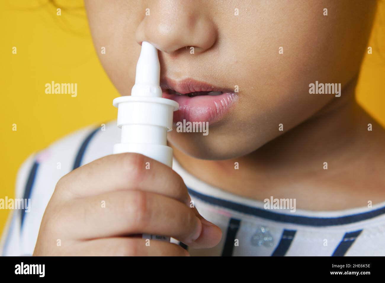 close up of sick child using nasal medicine spray Stock Photo Alamy
