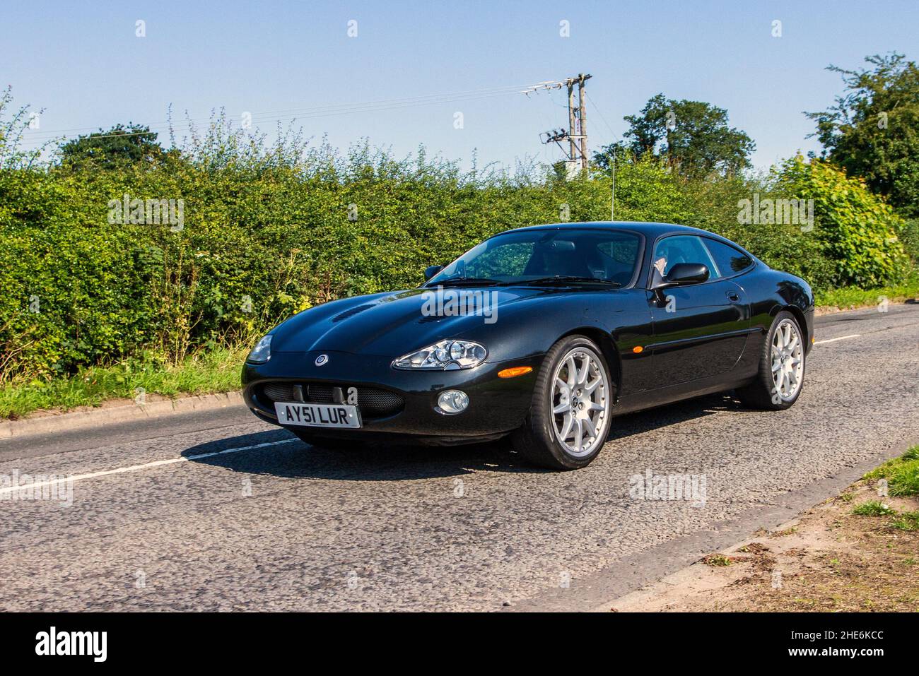 2001 black Jaguar XKR 3996cc automatic, 5.0 V8 supercharged 2dr auto coupe en-route to Capesthorne Hall classic July car show, Cheshire, UK Stock Photo