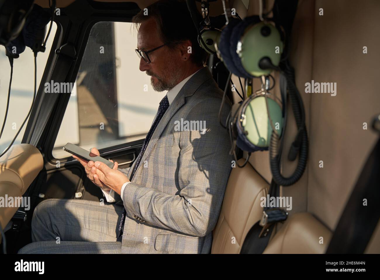 Serious focused man reading text message on smartphone Stock Photo