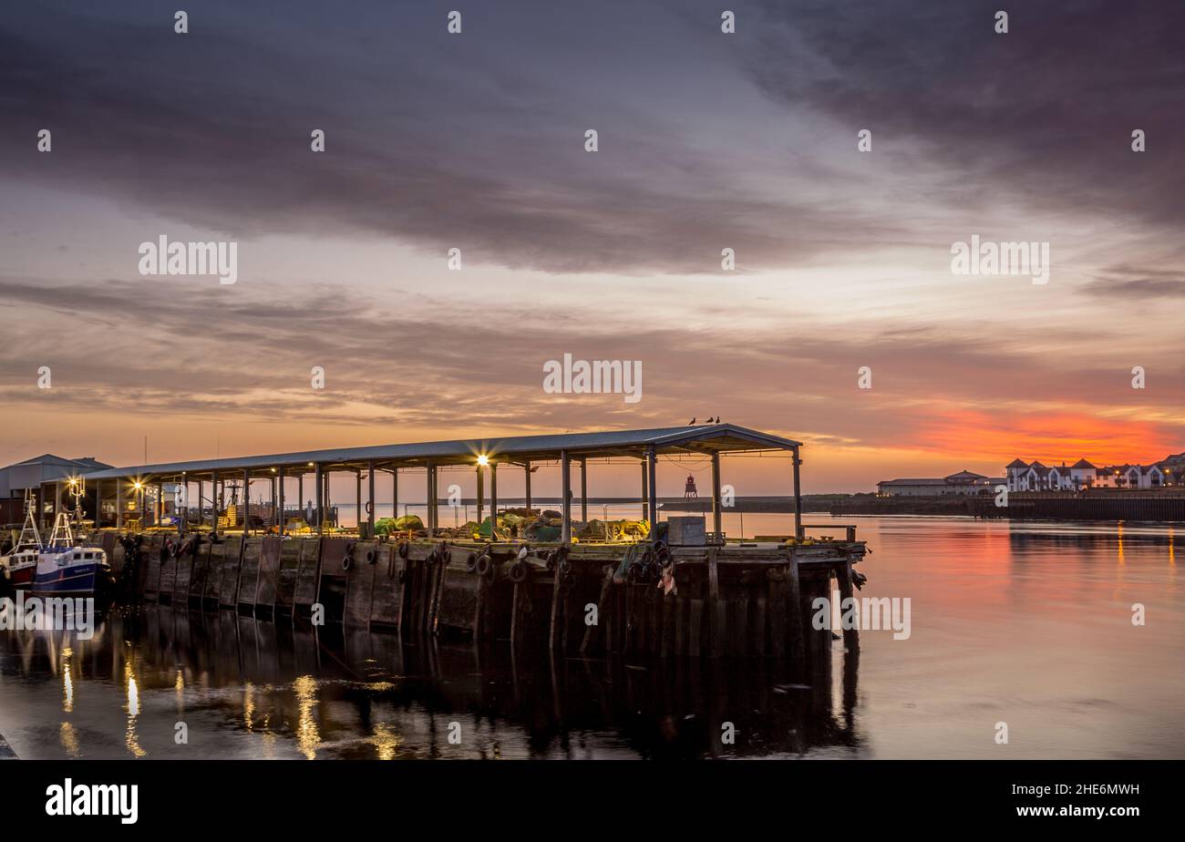 North Shields Fish Quay on a calm morning during a vivid sunrise Stock Photo