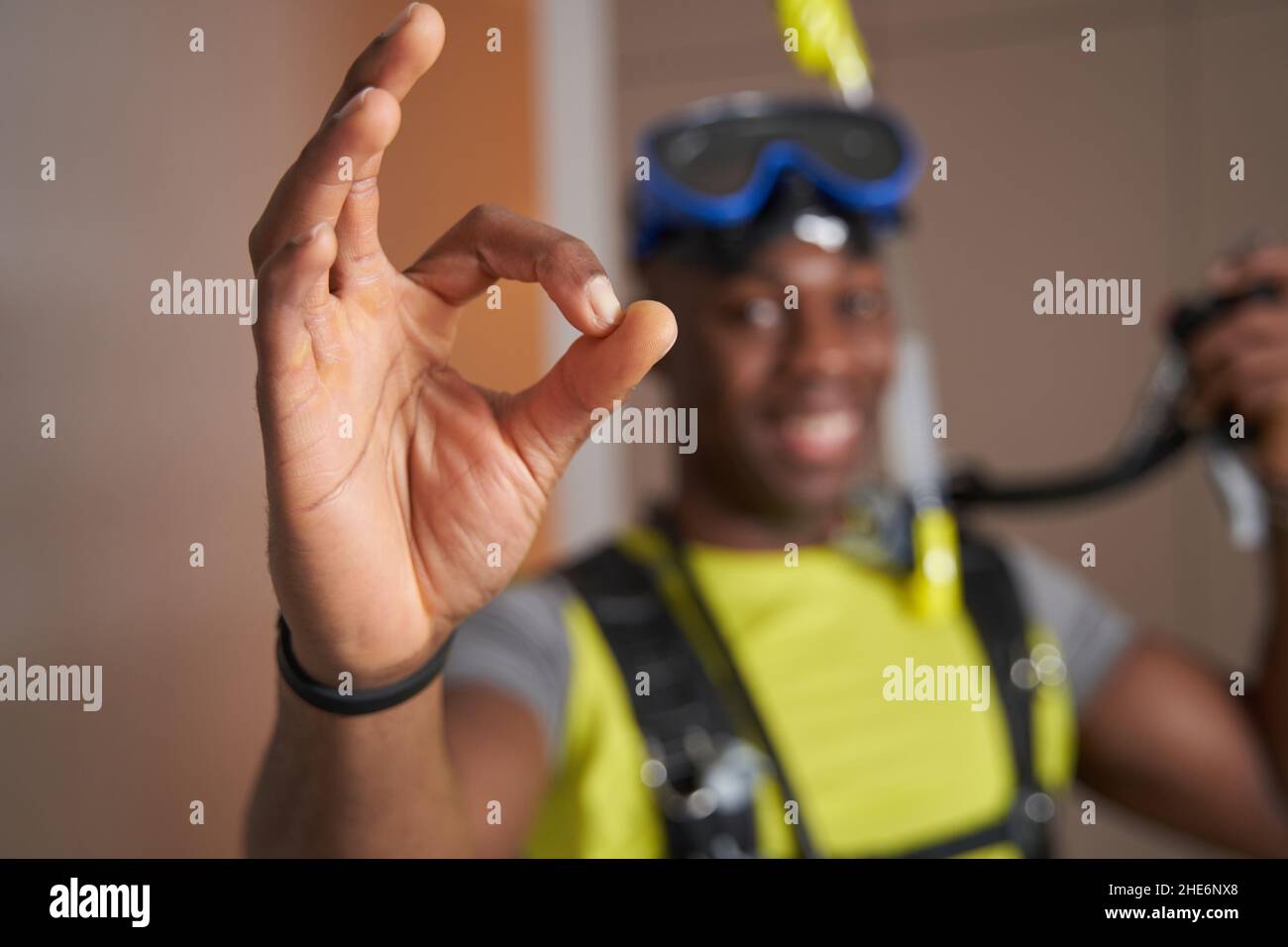 Hand of mixed-race man showing ok sign to camera Stock Photo