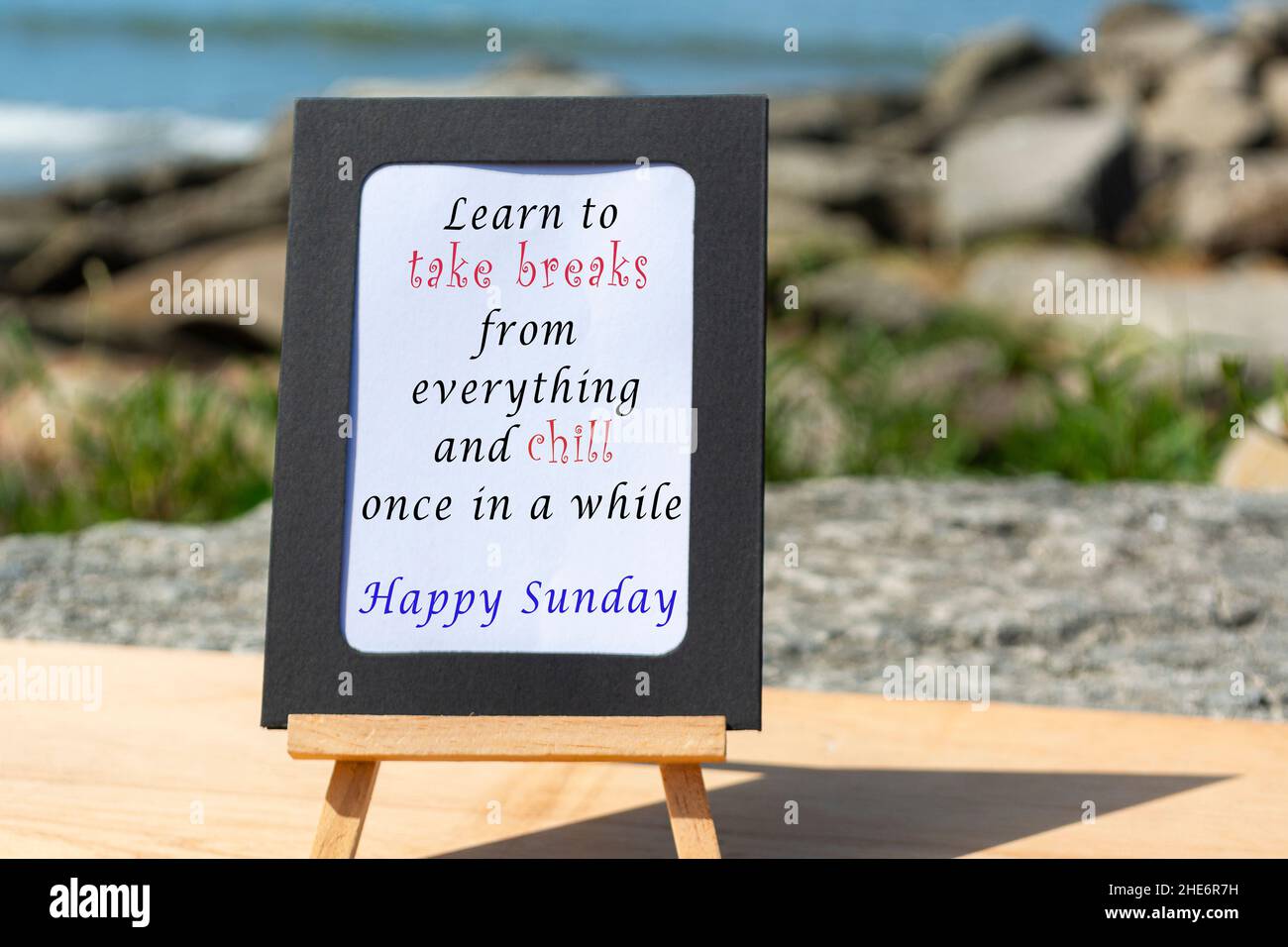 Motivational and Inspirational quote on a notepad with blurred beach background Stock Photo